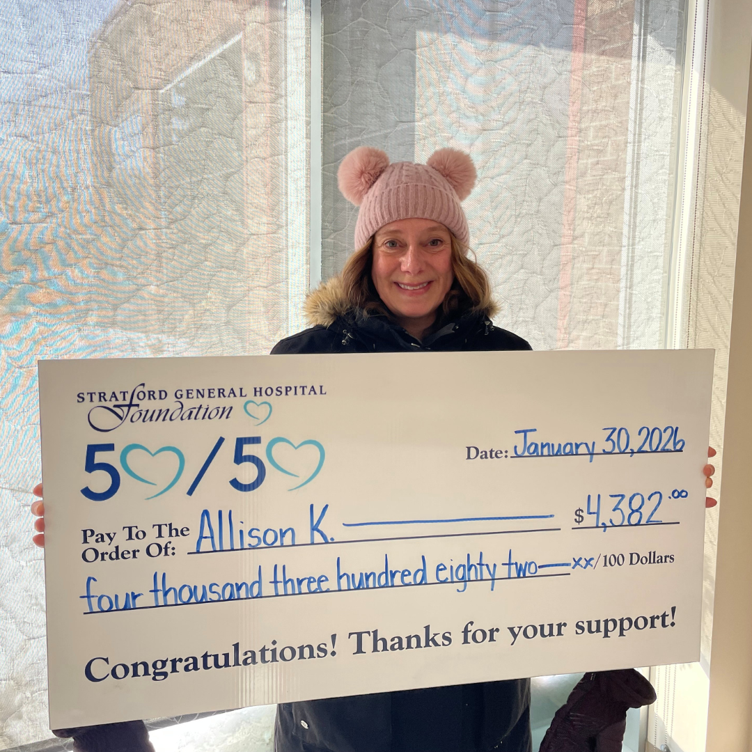 Allison, January's 50/50 Grand Prize Winner poses with an oversize novelty cheque